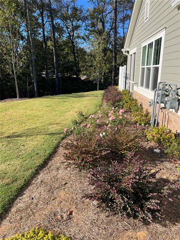 704 Calypso Way Cumming, GA 30040 - Photo 3 of 33 a view of a yard with a house