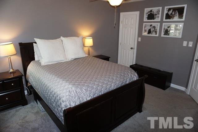 215 Danforth Drive Cary, NC 27511 - Photo 13 of 25 a bedroom with a bed and painting on the wall
