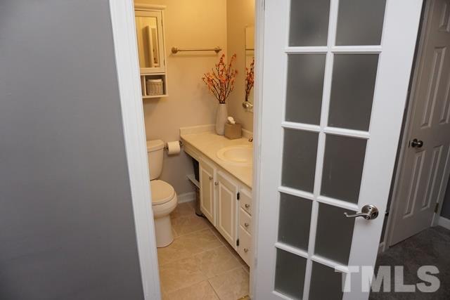215 Danforth Drive Cary, NC 27511 - Photo 15 of 25 a bathroom with a granite countertop sink toilet and shower