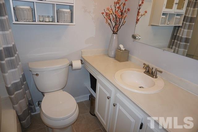 215 Danforth Drive Cary, NC 27511 - Photo 16 of 25 a bathroom with a toilet sink and mirror