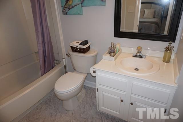 215 Danforth Drive Cary, NC 27511 - Photo 19 of 25 a bathroom with a sink a toilet and a mirror