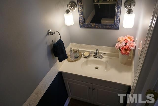 215 Danforth Drive Cary, NC 27511 - Photo 20 of 25 a bathroom with a sink vanity and mirror