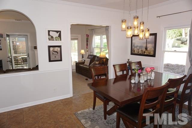 215 Danforth Drive Cary, NC 27511 - Photo 3 of 25 a view of a dining room with furniture and chandelier