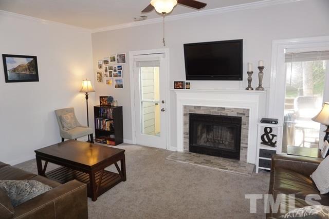 215 Danforth Drive Cary, NC 27511 - Photo 8 of 25 a living room with furniture a flat screen tv and a fireplace
