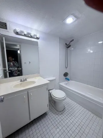a bathroom with a toilet a sink and bathtub