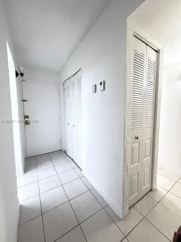 a view of a livingroom with an empty space and a hallway