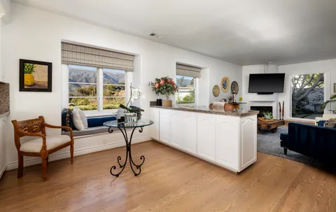 a white kitchen with stainless steel appliances granite countertop a stove a sink and white cabinets
