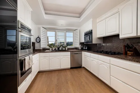 a kitchen with stainless steel appliances a stove sink and microwave