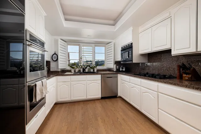 a kitchen with stainless steel appliances a stove sink and microwave