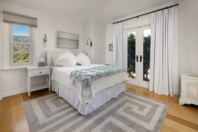 a bathroom with a granite countertop sink a toilet and a mirror