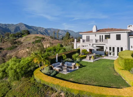 a backyard of a house with yard and outdoor seating