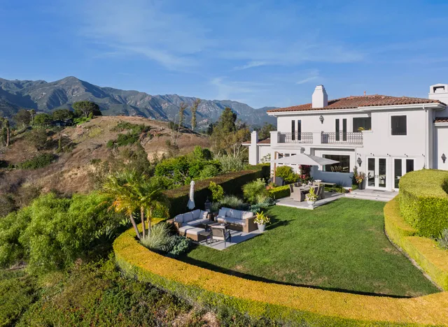 a backyard of a house with yard and outdoor seating