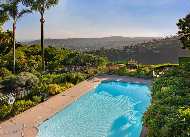 a view of a patio with table and chairs and potted plants