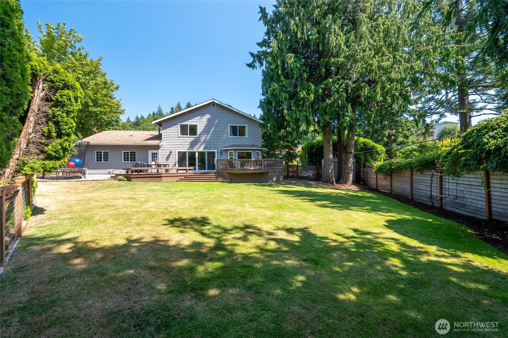 706 Fieldston Road Bellingham, WA 98225 - Photo 18 of 40 a view of a house with swimming pool and a yard