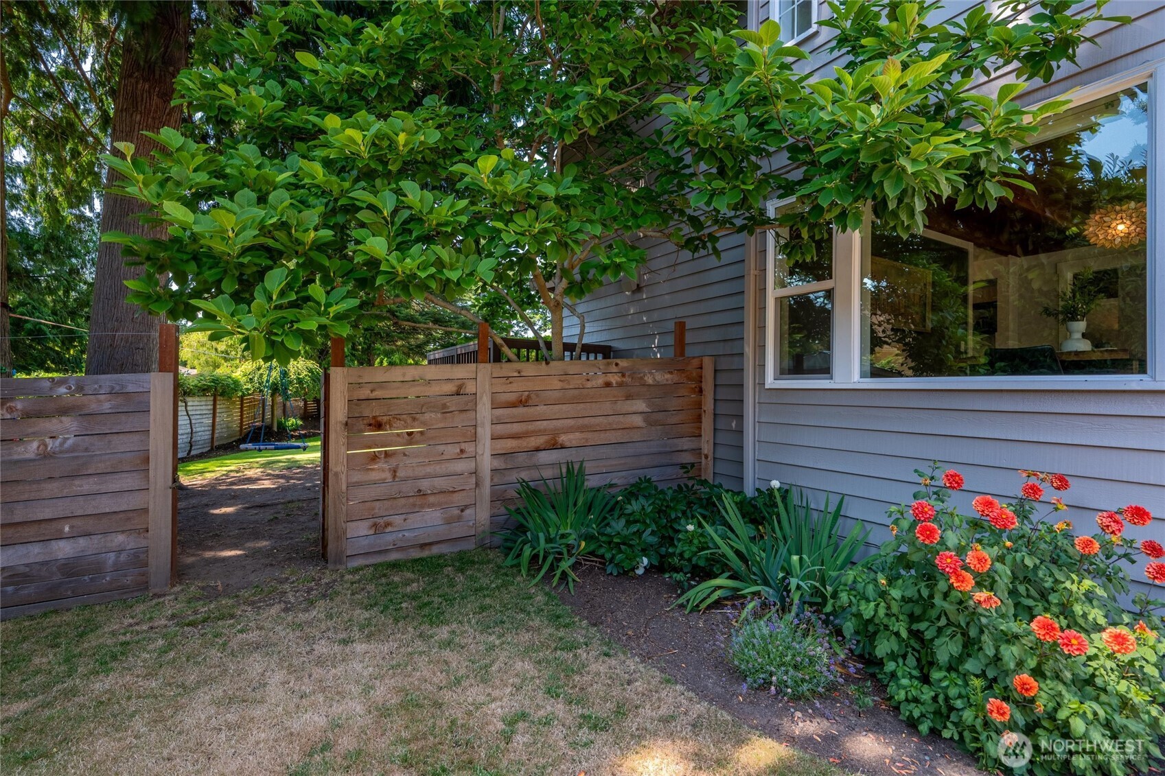 706 Fieldston Road Bellingham, WA 98225 - Photo 35 of 40 a view of a wooden house with a flower garden