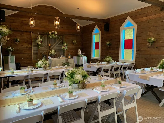 a view of a house with a yard and large tree