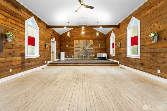 a view of outdoor space with wooden floor and windows