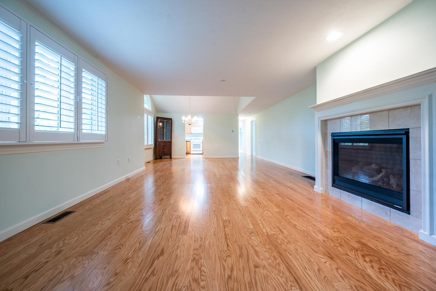 20 North Ridge Road Mashpee, MA 02649 - Photo 5 of 14 an empty room with wooden floor fireplace and windows