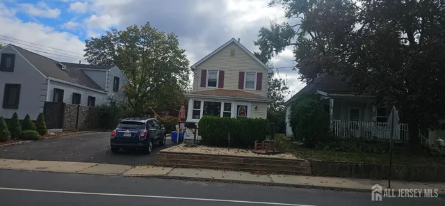 a car parked in front of a brick house