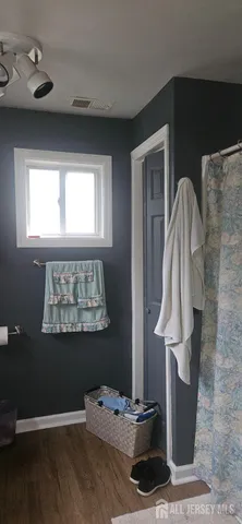 a bathroom with a toilet a sink and curtain