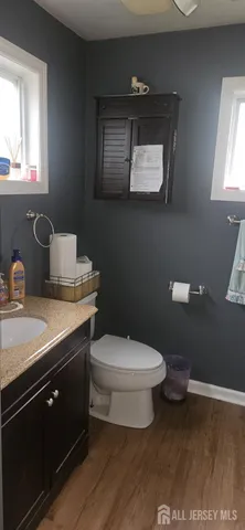 a kitchen with stainless steel appliances kitchen island granite countertop a table chairs in it and wooden floors