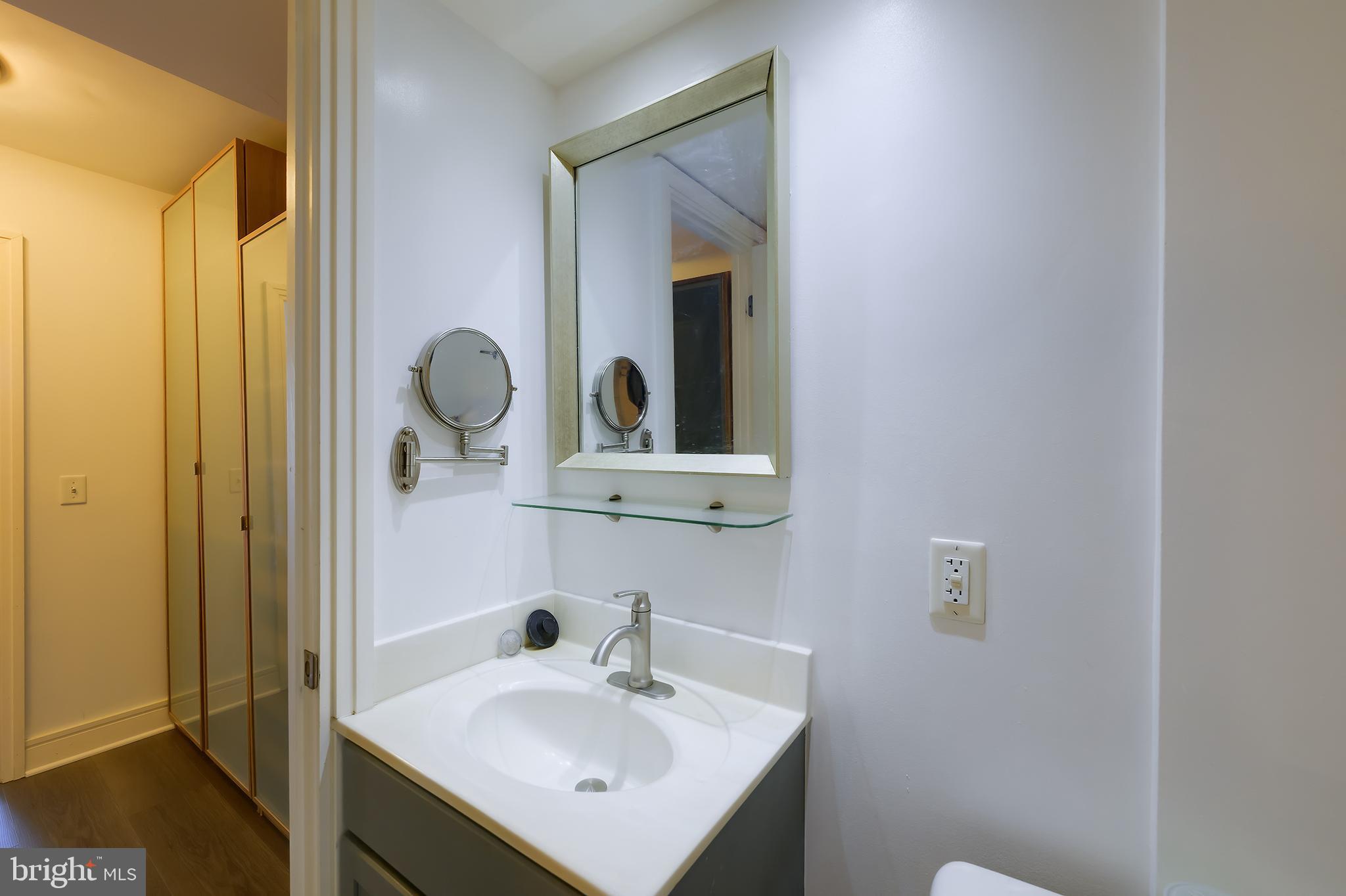 800 4th Street Southwest, Unit N518 Washington, DC 20024 - Photo 17 of 26 a bathroom with a sink and a mirror