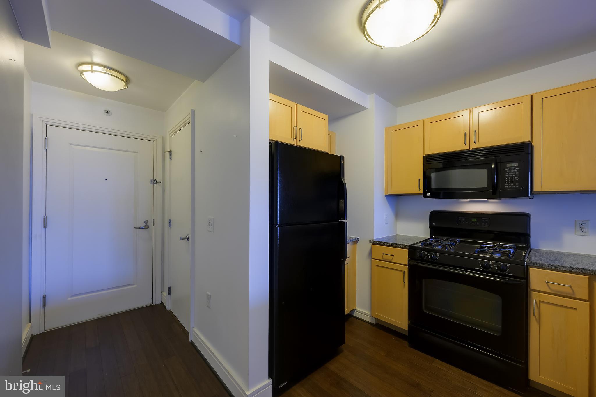 800 4th Street Southwest, Unit N518 Washington, DC 20024 - Photo 4 of 26 a kitchen with a refrigerator stove and microwave