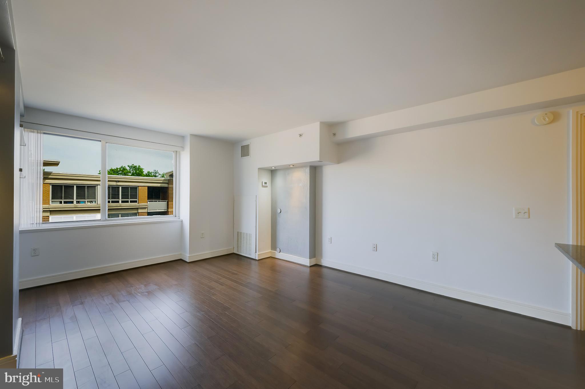 800 4th Street Southwest, Unit N518 Washington, DC 20024 - Photo 7 of 26 a view of an empty room with wooden floor and windows