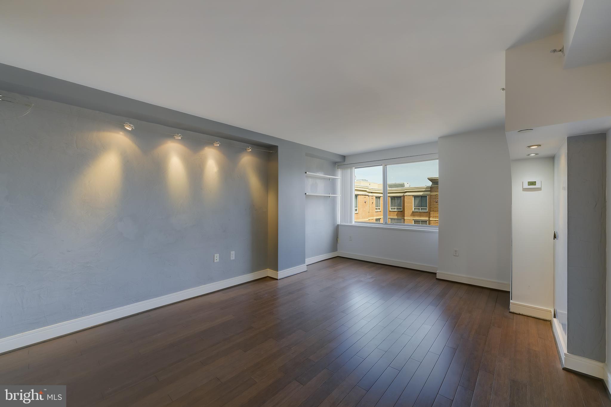 800 4th Street Southwest, Unit N518 Washington, DC 20024 - Photo 9 of 26 an empty room with wooden floor and windows