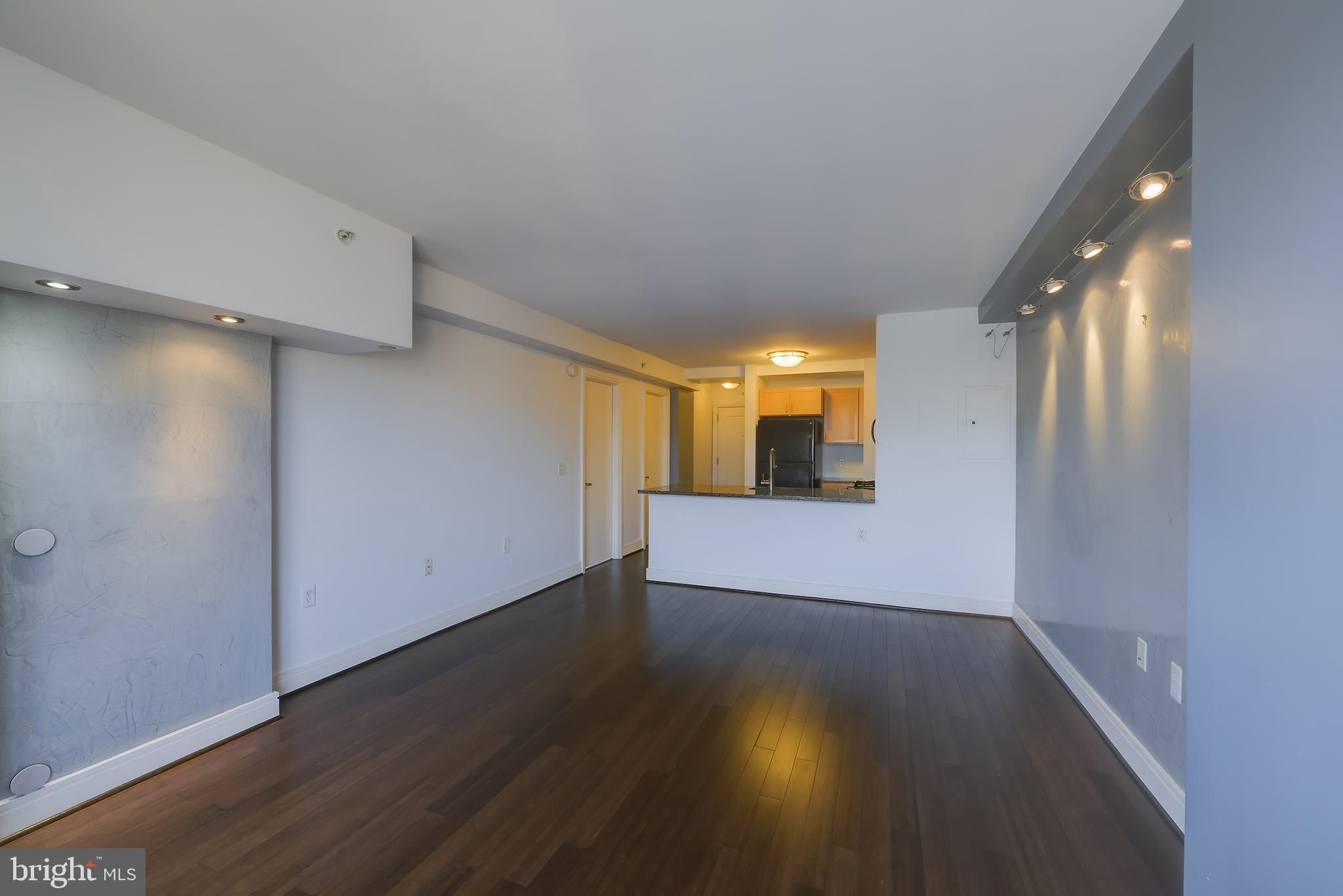 800 4th Street Southwest, Unit N518 Washington, DC 20024 - Photo 10 of 26 an empty room with wooden floor and windows