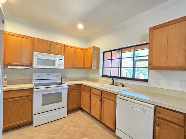 a kitchen with a sink stove oven and window
