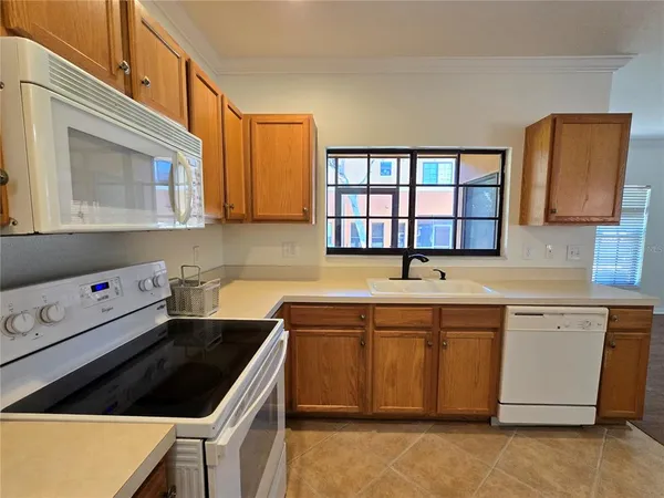a kitchen that has a sink and a stove in it