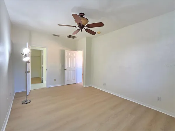 a view of a livingroom with a ceiling fan and window