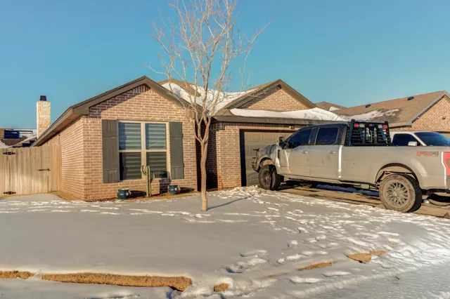 a view of a house with wooden fence