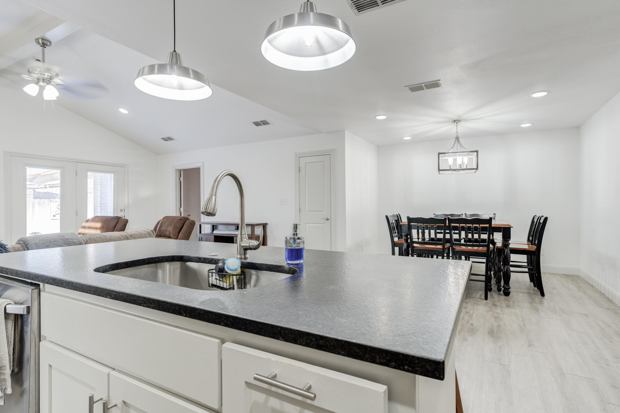 7020 24th Street Lubbock, TX 79407 - Photo 12 of 31 a view of a dining room with furniture window and wooden floor