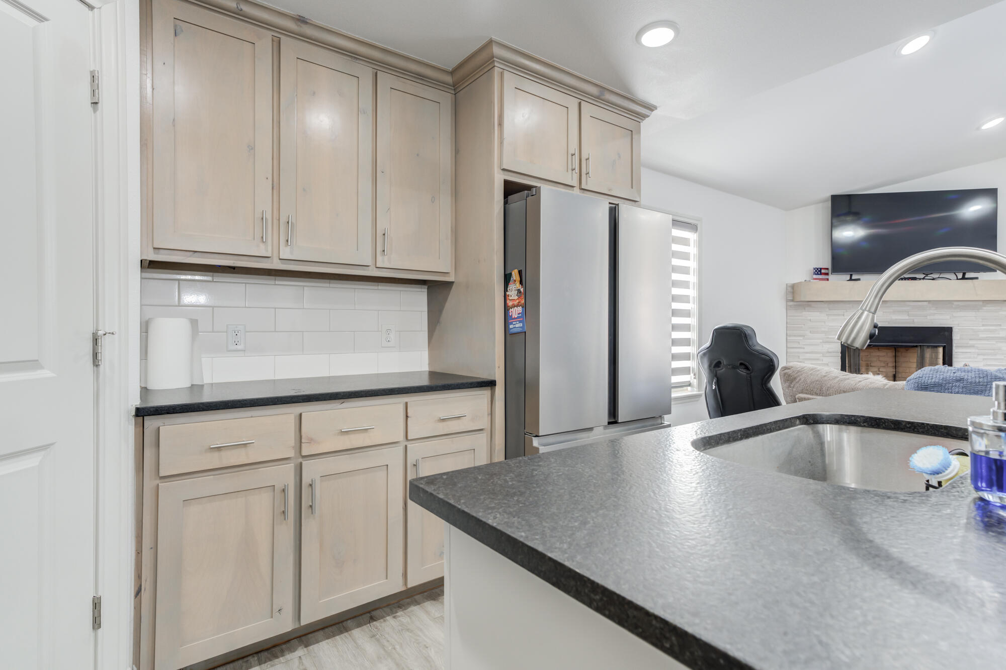 7020 24th Street Lubbock, TX 79407 - Photo 14 of 31 a kitchen with stainless steel appliances granite countertop a refrigerator a sink and white cabinets