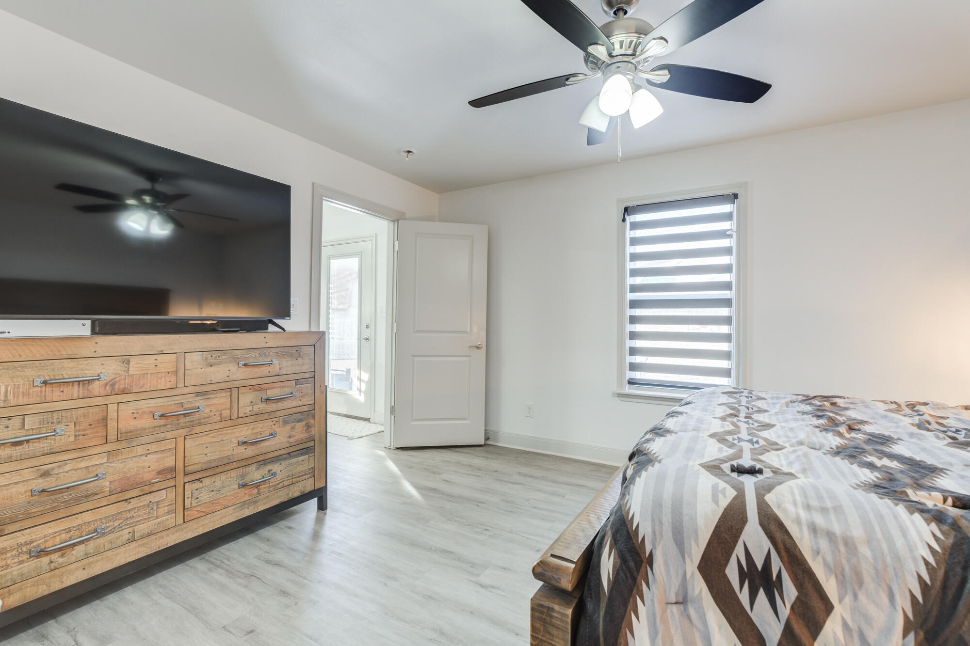 7020 24th Street Lubbock, TX 79407 - Photo 18 of 31 a bedroom with a bed and a flat screen tv