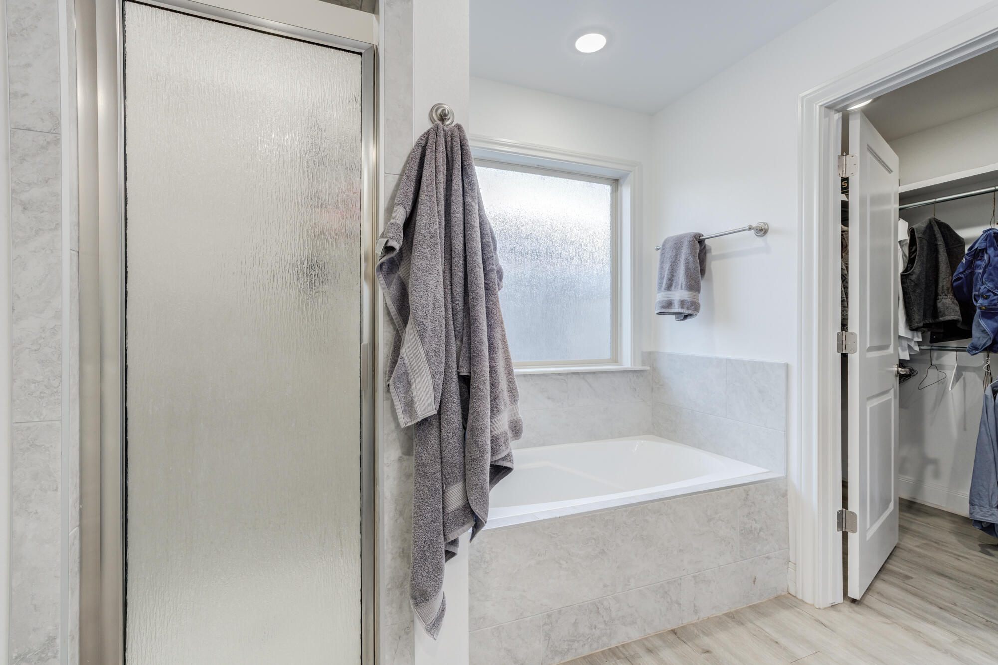 7020 24th Street Lubbock, TX 79407 - Photo 21 of 31 a bathroom with a bathtub and a shower