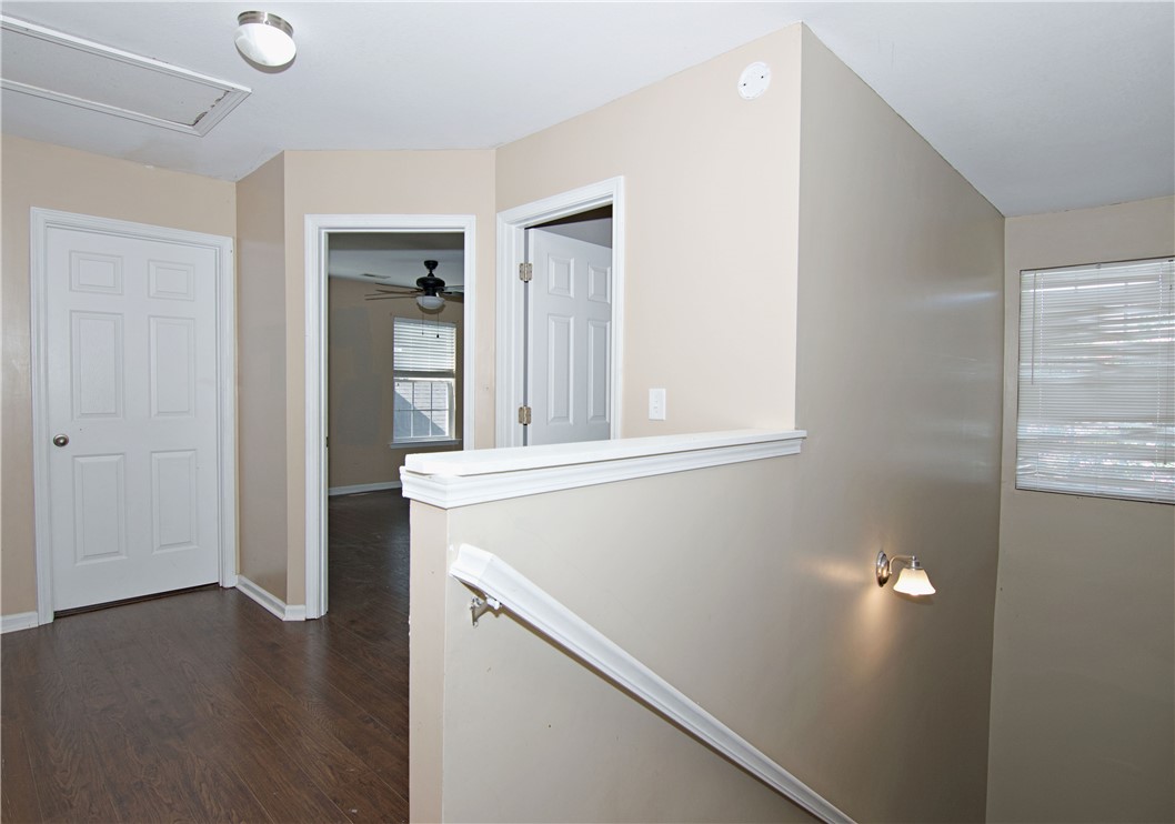 305 North Chestnut Street Seneca, SC 29678 - Photo 24 of 44 Hardwood floors and a pristine ceiling fan provide comfort in this upper-level hallway.
