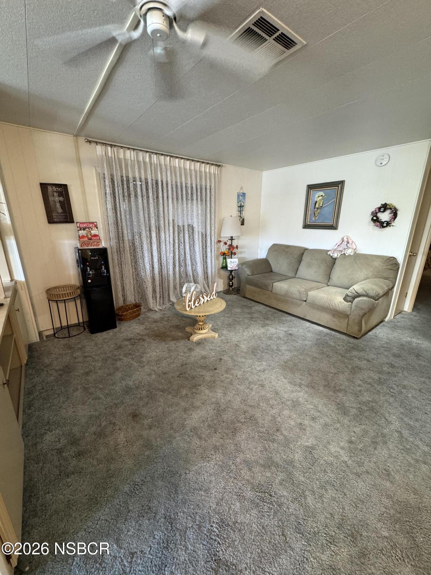 3210 Santa Maria Way, Unit 173 Santa Maria, CA 93455 - Photo 7 of 24 a living room with furniture and a flat screen tv