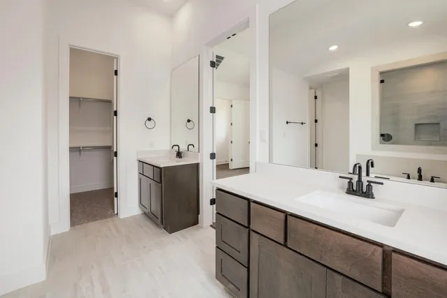 a bathroom with a tub a sink and mirror