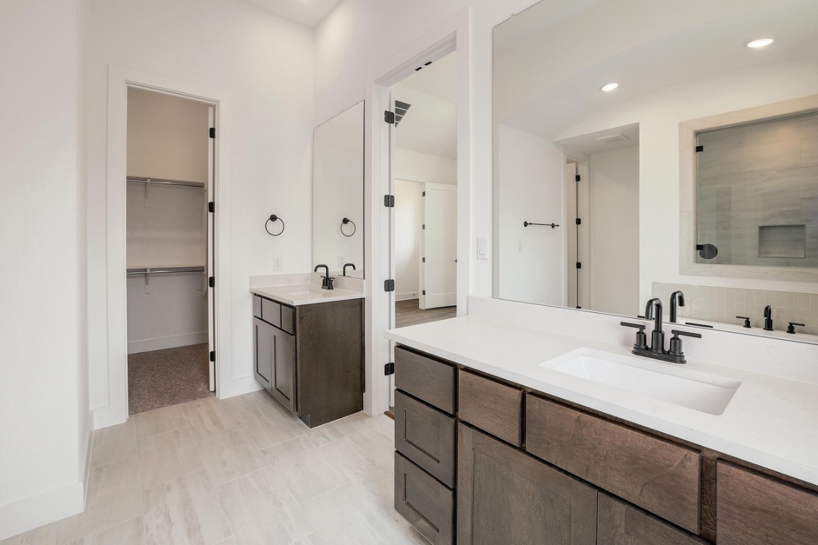 1604 Lilly Grace Bend Leander, TX 78641 - Photo 12 of 22 a bathroom with a sink double vanity and a mirror