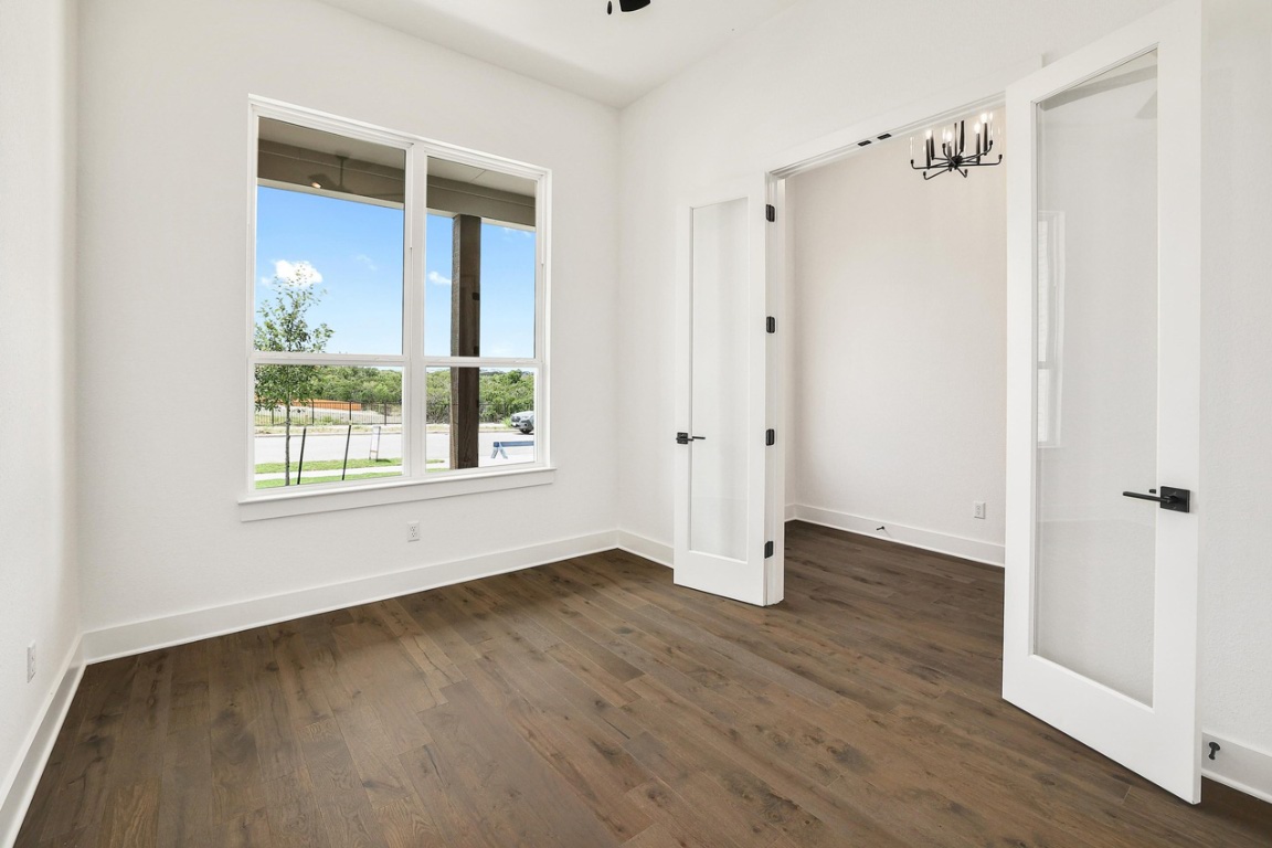 1604 Lilly Grace Bend Leander, TX 78641 - Photo 14 of 22 a view of an empty room with wooden floor and a window