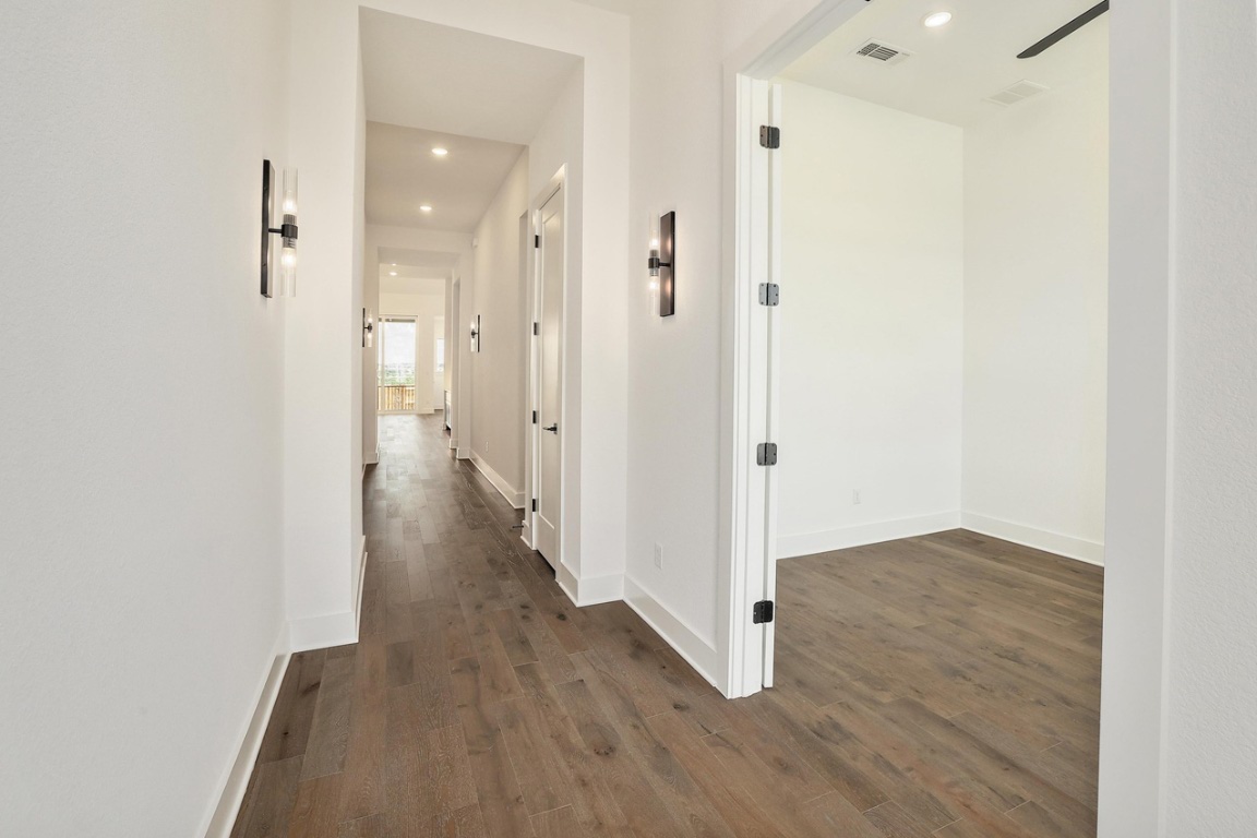 1604 Lilly Grace Bend Leander, TX 78641 - Photo 15 of 22 a view of a hallway with wooden floor