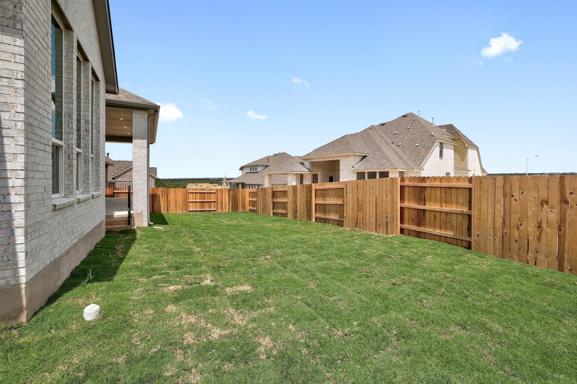 1604 Lilly Grace Bend Leander, TX 78641 - Photo 20 of 22 a view of a house with a backyard