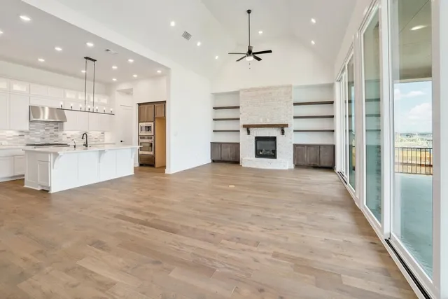 a kitchen with granite countertop a sink and a stove top oven