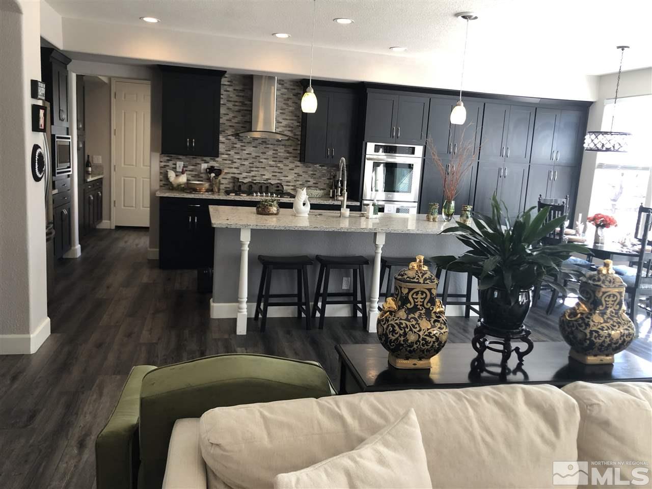 2963 Stonebridge Trail Reno, NV 89511 - Photo 8 of 21 a living room with stainless steel appliances kitchen island granite countertop furniture and wooden floor