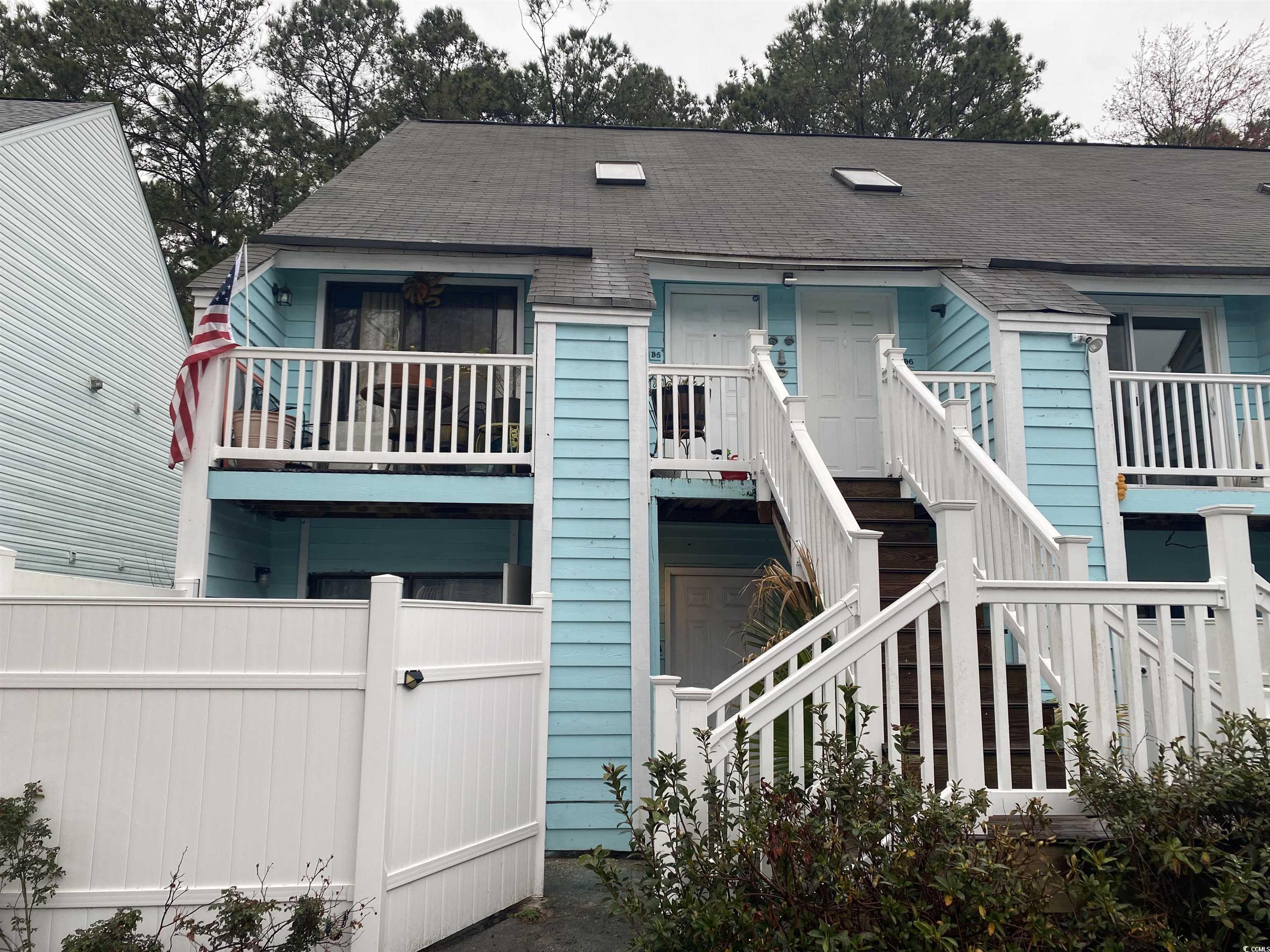 405 Cambridge Circle, Unit B5 Murrells Inlet, SC 29576 - Photo 2 of 14 View of front of property featuring stairway, roof