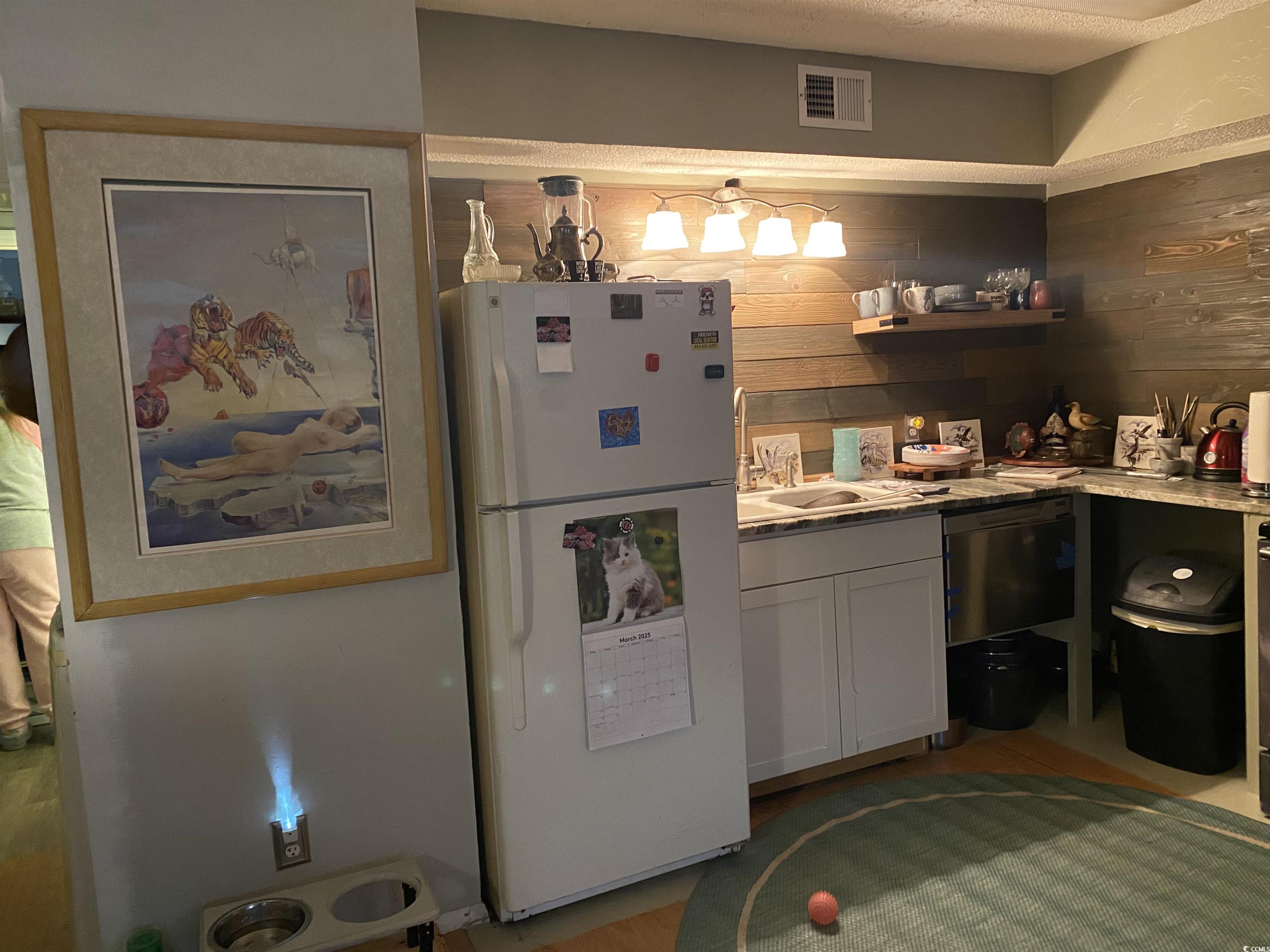 405 Cambridge Circle, Unit B5 Murrells Inlet, SC 29576 - Photo 4 of 14 Kitchen with visible vents, wooden walls, light co