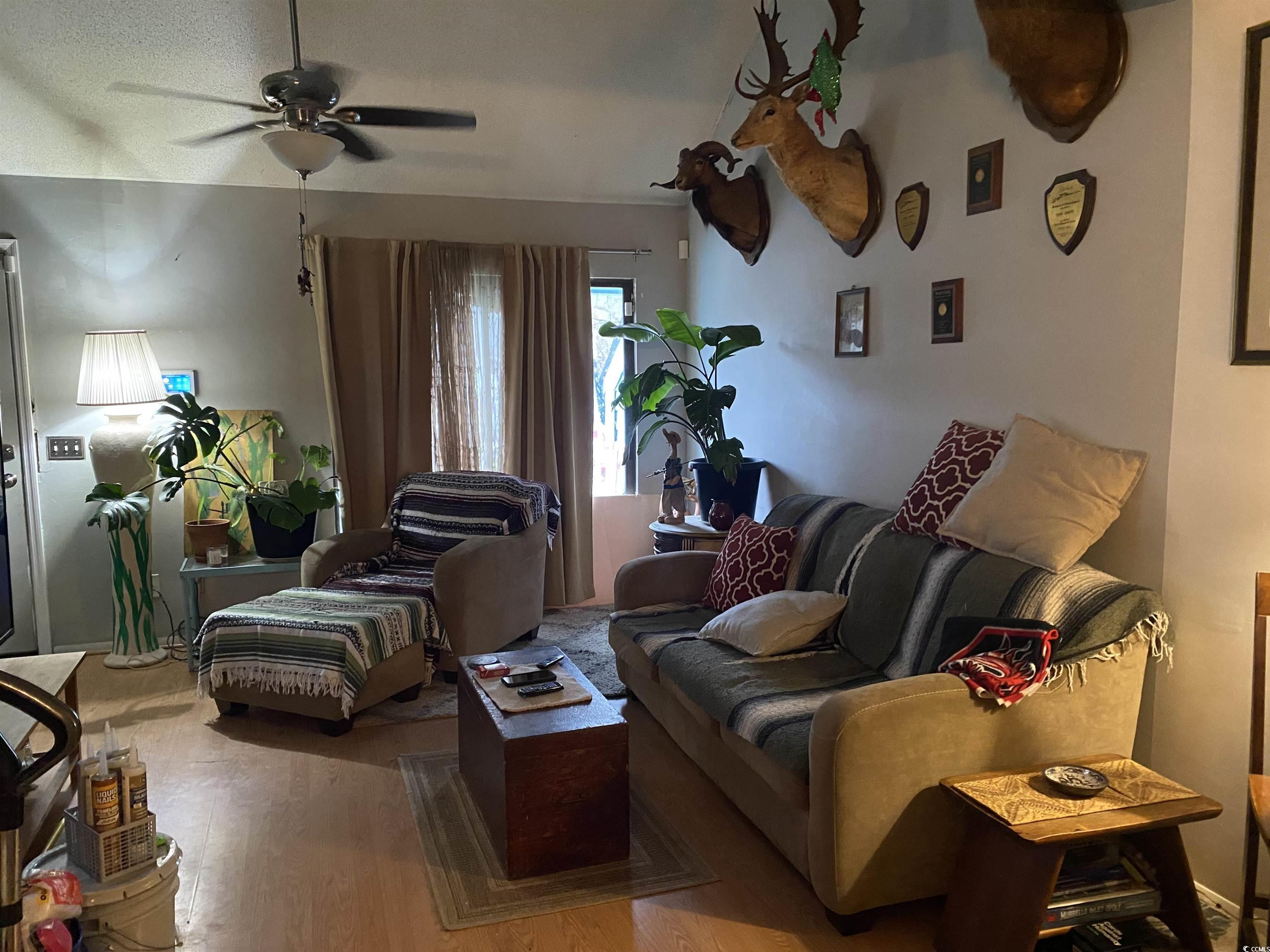 405 Cambridge Circle, Unit B5 Murrells Inlet, SC 29576 - Photo 6 of 14 Living area with a ceiling fan and wood finished f